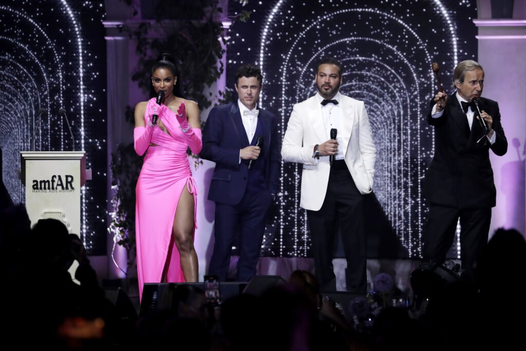 amfAR Gala Cannes 2022 - Show - Gossip Stone TV - Exclusive Celebrity Shows, Fashion, and Luxury News CAP D'ANTIBES, FRANCE - MAY 26: (L-R) Casey Affleck, Ciara Wilson, Roheen Berry and Simon de Pury stand on stage during the amfAR Cannes Gala 2022 at Hotel du Cap-Eden-Roc on May 26, 2022 in Cap d'Antibes, France. (Photo by John Phillips/amfAR/Getty Images for amfAR)