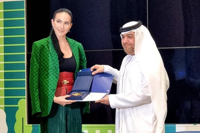 Debbie Wingham receiving a REAL gold award on national day